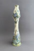 Hoge vaas van plateelbakkerij Zuid-Holland uit de periode 1902-907, model 322, beschilderd met een P/b-decor met paarse bloemen door Francien Sanderus.