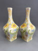 Paar vazen van Ivora Gouda, model 206 van 31,5 cm hoog, beschilderd met een floraal 'kantjes' decor, circa 1920.